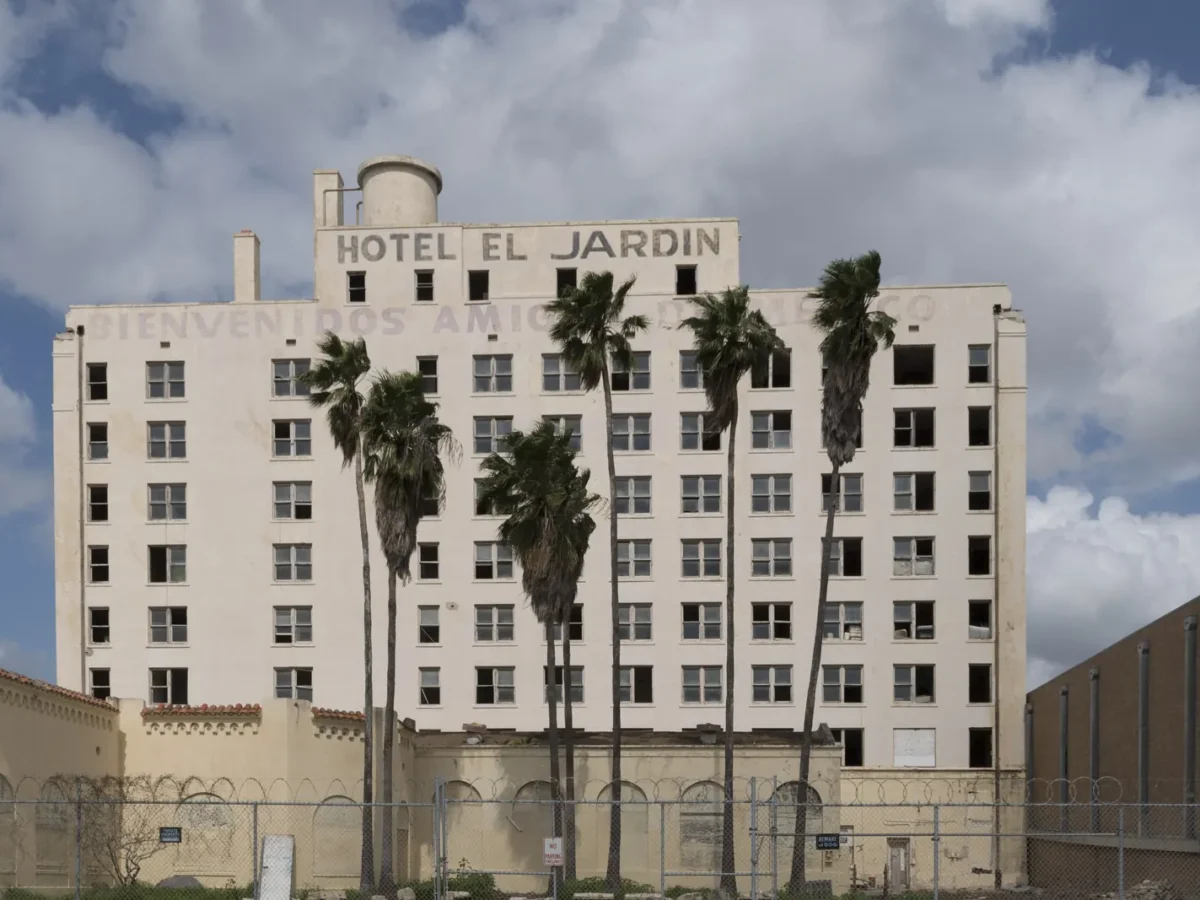 The historic El Jardin Hotel with palm trees in Brownsville, Texas