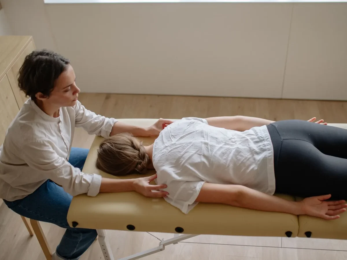 Chiropractor adjusting a patient on a treatment table