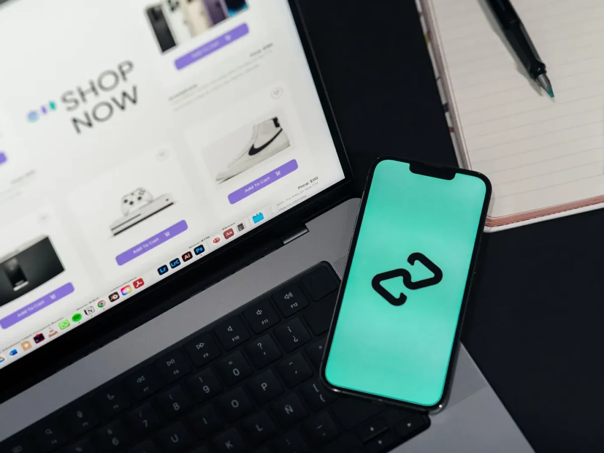 Laptop showing an online store next to a phone