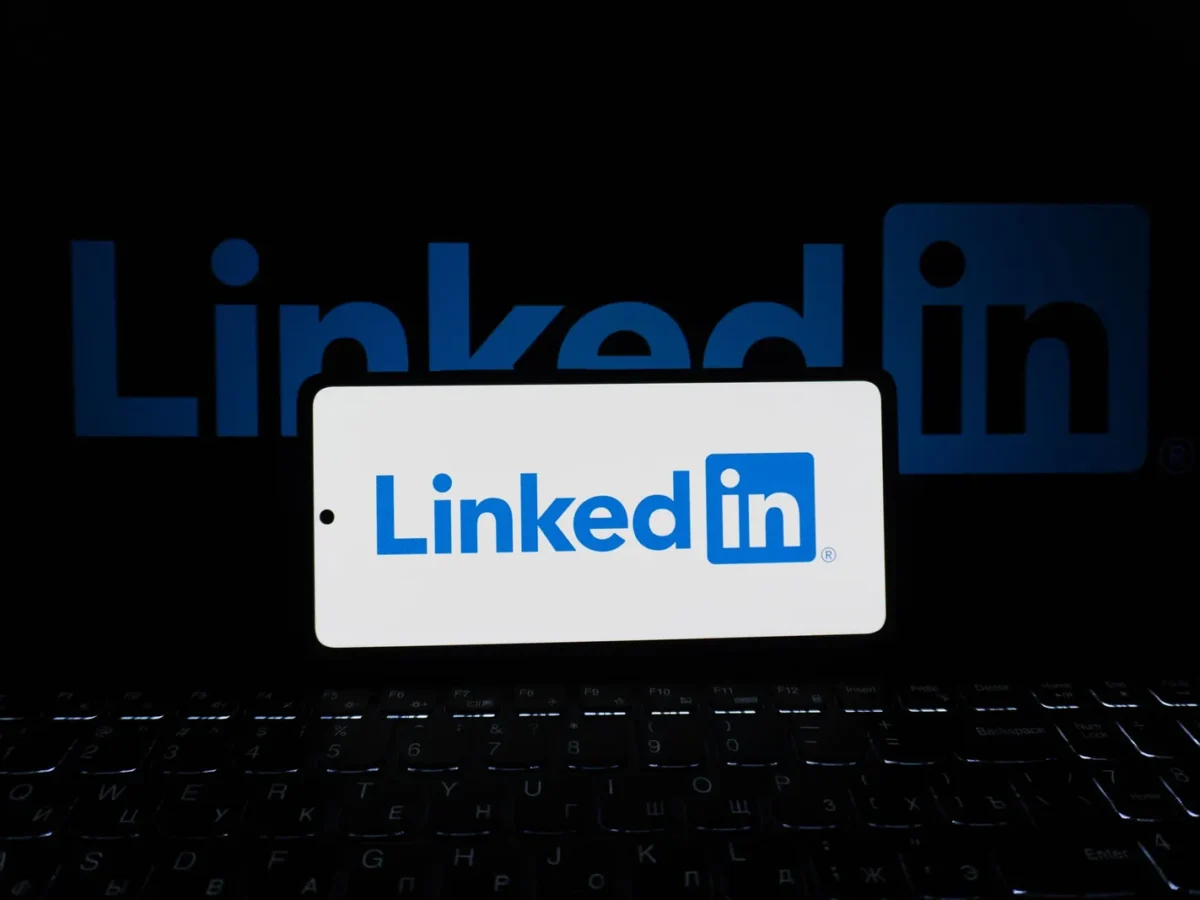 Phone showing the LinkedIn logo in front of a keyboard