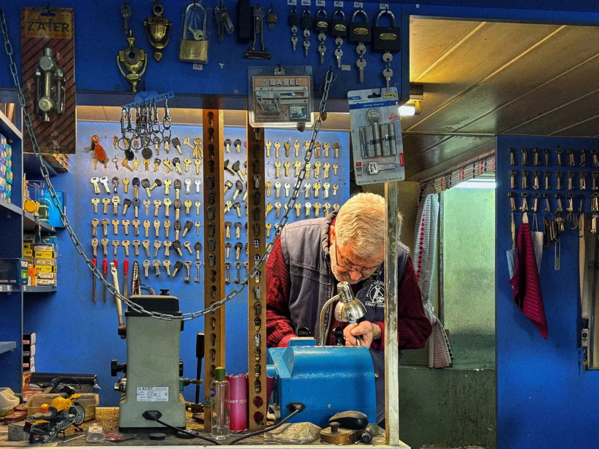 Locksmith cutting a key in his shop