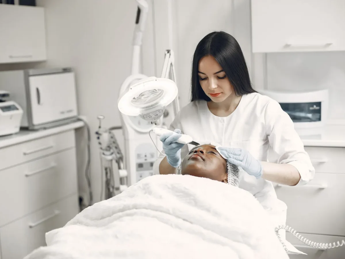 Aesthetician giving a facial treatment in a clinic