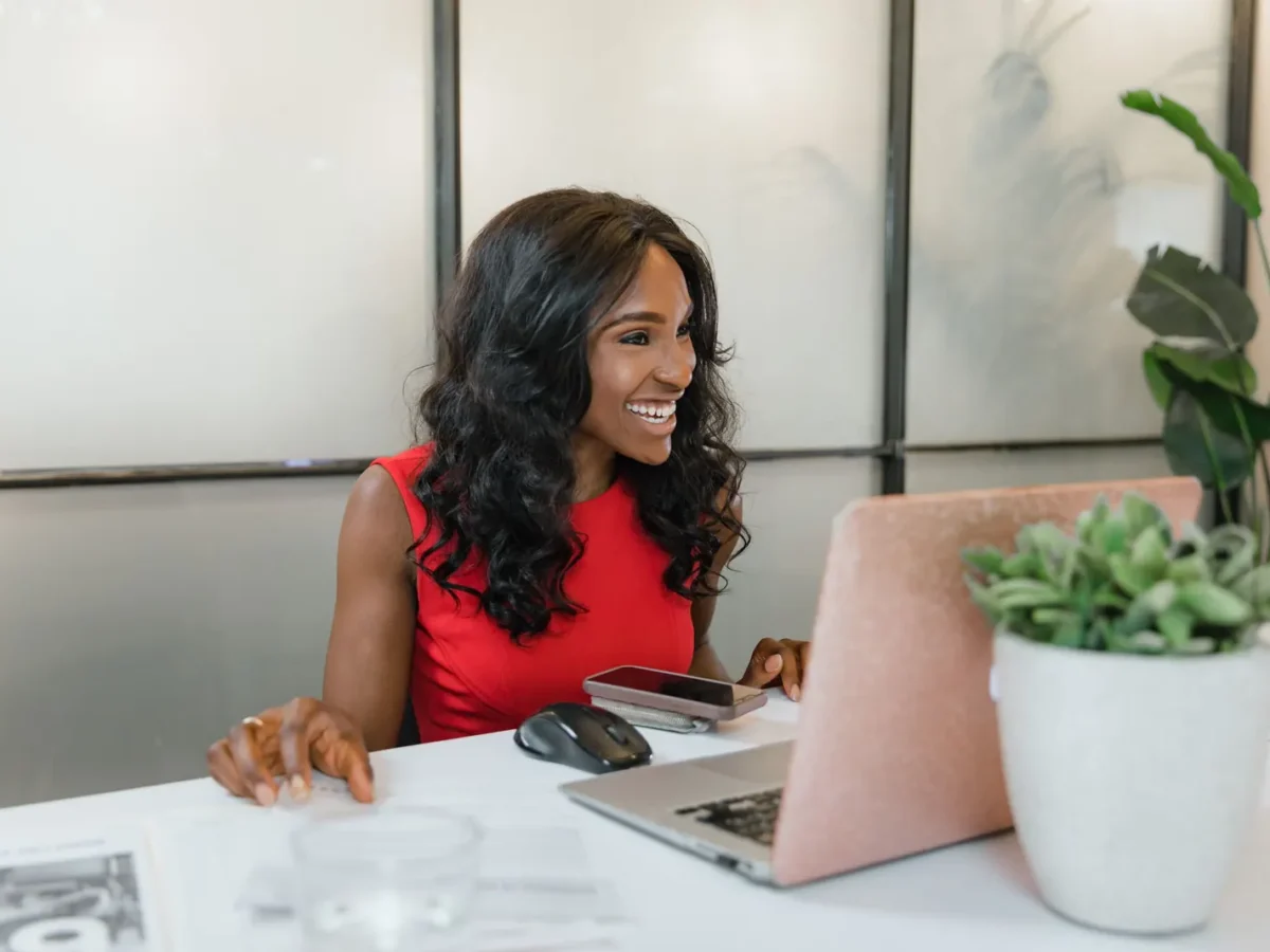 Business owner smiling while working on a laptop