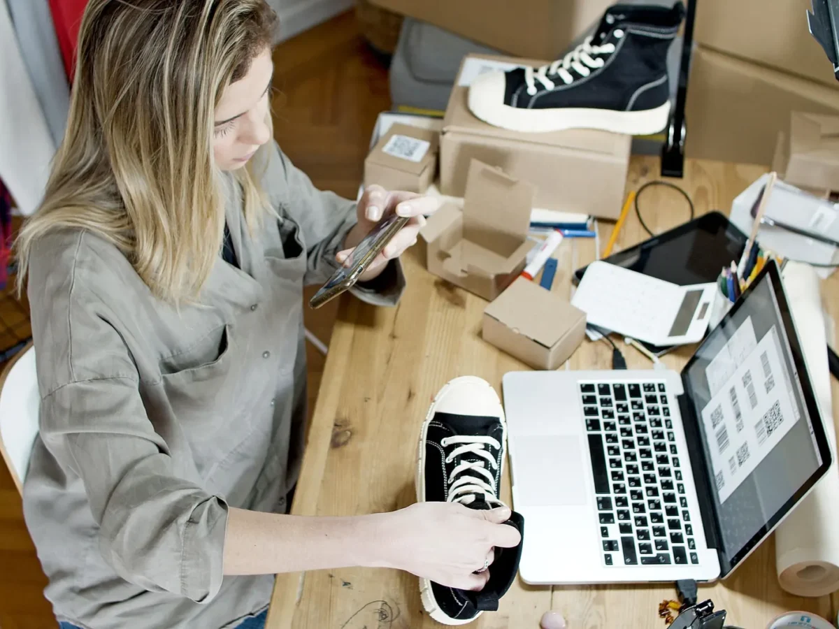 Online seller photographing sneakers for a product listing