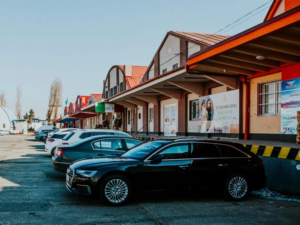 Row of storefronts with a parking lot in front