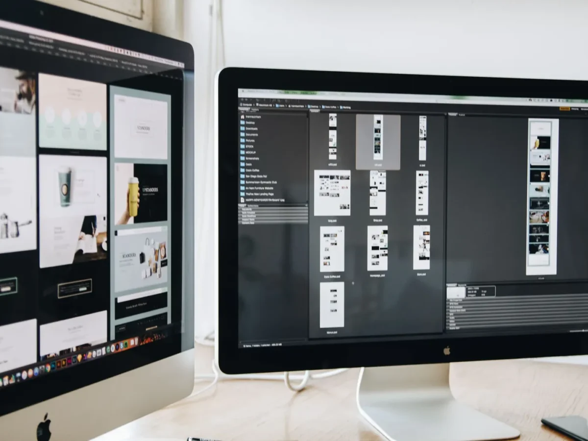 Web designer's two monitors showing page layouts